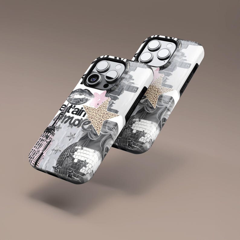 May include: Two phone cases with a monochrome design featuring a disco ball, Eiffel Tower, and text. One case has a pink flower and a leopard print star. The other case has a leopard print star. The cases have a black border.