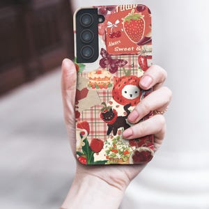 May include: A phone case with a collage of strawberry-themed illustrations. The design includes strawberries, cherries, a butterfly, a cat, and the text "Always Sweet &" on a cream-colored background.