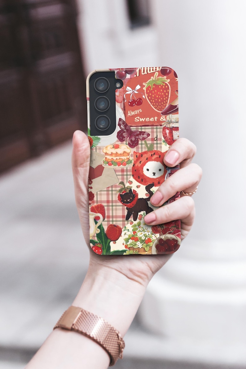 May include: A phone case with a collage of strawberry-themed illustrations. The design includes strawberries, cherries, a butterfly, a cat, and the text "Always Sweet &" on a cream-colored background.