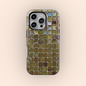 May include: A phone case with a mosaic tile design. The case features a pattern of small, square tiles in shades of brown, gold, and green, with iridescent accents. The case has a black border and cutouts for the phone's camera and buttons.