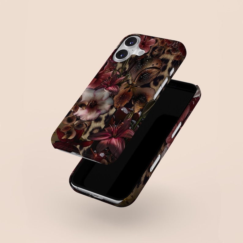 May include: A phone case with a floral and leopard print design. The case features a dark background with burgundy and white flowers, and a leopard print pattern. The phone case is shown with the phone inside.