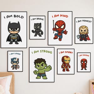 May include: A set of eight framed wall art prints featuring cartoon-style superheroes. Each print displays a character with a positive affirmation text, including I AM BOLD, I AM BRAVE, I AM KIND, I AM HONEST, I AM LOVED, I AM STRONG, I AM SMART, and I AM UNIQUE.