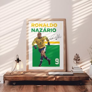 May include: A framed poster featuring Ronaldo Naz&aacute;rio in a yellow and blue soccer uniform. The poster has a green and white background with the number 9. The name "Ronaldo Naz&aacute;rio" is printed in yellow and green.