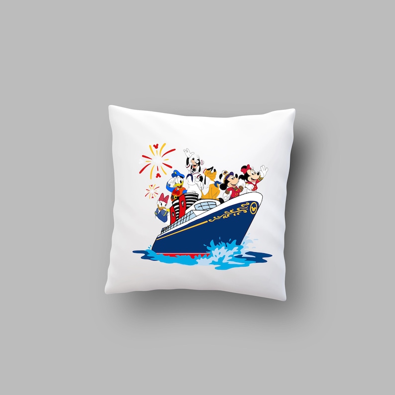 May include: White pillow with a colorful illustration of Mickey Mouse, Minnie Mouse, Donald Duck, Goofy, and Pluto on a blue and white cruise ship with red, white, and blue fireworks in the background.