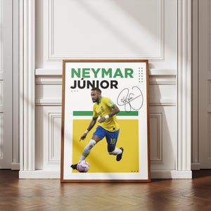 May include: A framed poster featuring Neymar J&uacute;nior in a yellow and blue soccer uniform, kicking a soccer ball. The poster includes the player's name in green and black text, along with a signature. The background is yellow and white.