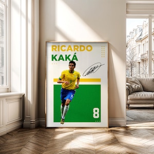 May include: Framed poster featuring Ricardo Kak&aacute; in a yellow and blue soccer uniform, running on a green background. The poster includes his name, signature, and the number 8. The background is white with yellow accents.