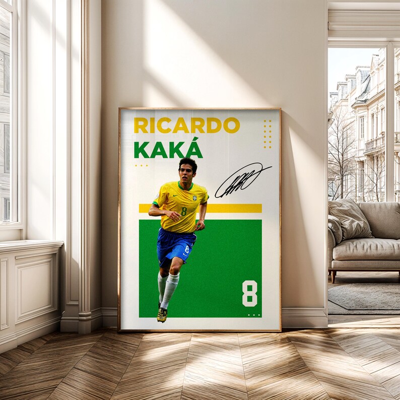 May include: Framed poster featuring Ricardo Kak&aacute; in a yellow and blue soccer uniform, running on a green background. The poster includes his name, signature, and the number 8. The background is white with yellow accents.