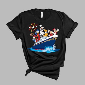 May include: Black t-shirt with a graphic of Mickey Mouse, Donald Duck, Goofy, and Pluto on a blue and gold cruise ship with fireworks in the background.