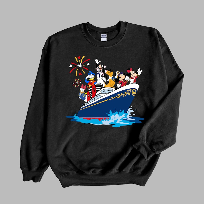 May include: Black sweatshirt with a graphic of Mickey Mouse, Donald Duck, Goofy, Pluto, and Minnie Mouse on a blue and white cruise ship with fireworks in the background.