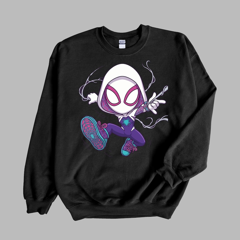 May include: A black crewneck sweatshirt featuring a graphic illustration of a stylized character wearing a white hood, a purple and white suit with a spider emblem, and teal sneakers with pink laces, depicted in a dynamic jumping pose.