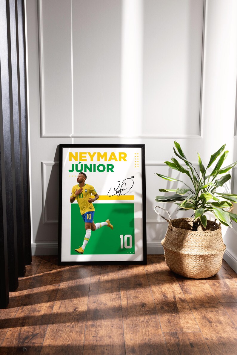 May include: Framed poster featuring Neymar J&uacute;nior in a yellow and blue soccer uniform, with the number 10. The poster has a green and white background with the player's signature and the name "NEYMAR J&Uacute;NIOR" in yellow and green.