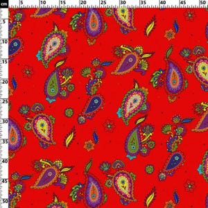 May include: A vibrant red fabric featuring a repeating paisley pattern in shades of purple, green, orange, and yellow. The design includes intricate teardrop shapes and small floral accents. A metric ruler is visible along the top and left edges.