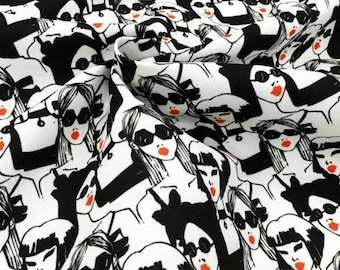 May include: White fabric with a repeating pattern of stylized women's faces. Each face features black sunglasses, red lipstick, and a black and white graphic design. The overall design is a bold, high-contrast pattern.