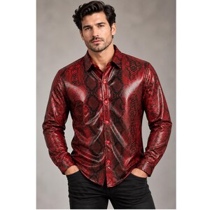 May include: A long-sleeved button-down shirt featuring a vibrant red and black snakeskin pattern. The garment has a classic collar, a front placket with matching red buttons, and a fitted silhouette, worn with plain black trousers.