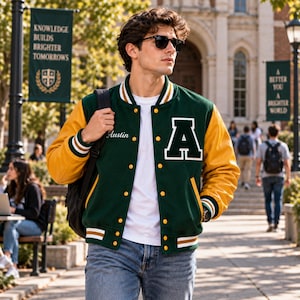 May include: A varsity jacket featuring a dark green wool-blend body with yellow leather sleeves, a white letter A on the chest, and the name Austin embroidered in white script. It includes yellow snap buttons, striped ribbed cuffs, and a white collar.