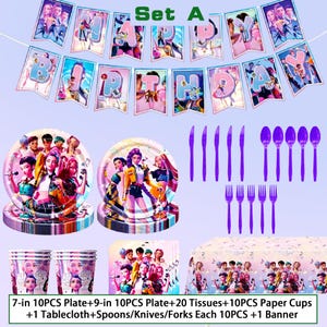 May include: A party set with a banner reading "HAPPY BIRTHDAY". The set includes plates, cups, napkins, a tablecloth, and purple cutlery. The items feature a colourful design with a group of animated characters.
