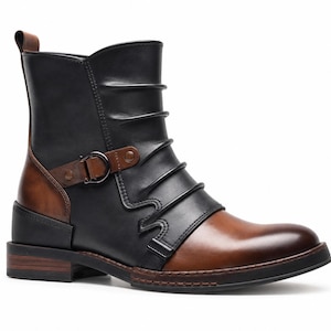 May include: A black and brown ankle boot featuring a smooth leather finish, a rounded toe, and a low stacked heel. The upper includes horizontal pleated detailing, a decorative side strap with a dark metal buckle, and a pull tab at the heel.