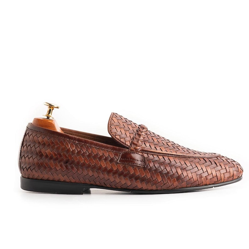 Side profile of handcrafted brown woven leather loafers for men with sleek slip-on silhouette, soft leather lining, luxury braided texture, lightweight formal shoe design, Italian-inspired driving loafers, and timeless gentleman style footwear.