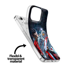 May include: A clear phone case with a design of a soccer player holding a trophy. The player is wearing a red and white jersey and is holding the trophy above his head. The background is a dark blue with stars.
