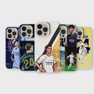 May include: A collection of phone cases featuring soccer player illustrations. The cases display various players in action, with team logos and player names. The designs include vibrant colors and dynamic poses, perfect for sports fans.