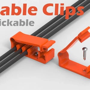 May include: Orange cable clips for organising wires. The clips are designed to be clickable and can be used to hold multiple wires together. The image shows two clips, one attached to a bundle of wires and the other separate.