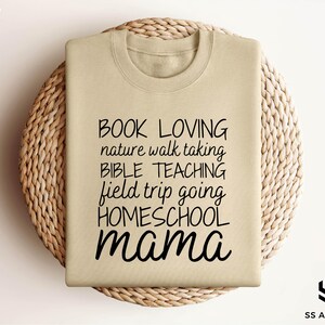 a t - shirt that reads book loving nature walking bible teaching held by going homes