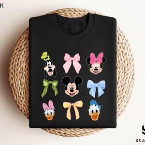 a black tshirt with mickey and minnie mouses on it