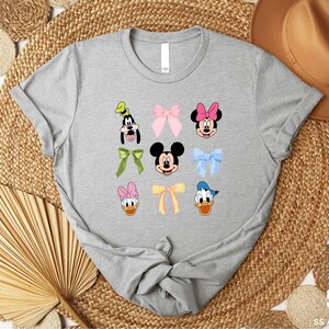 a gray shirt with mickey and minnie mouses on it