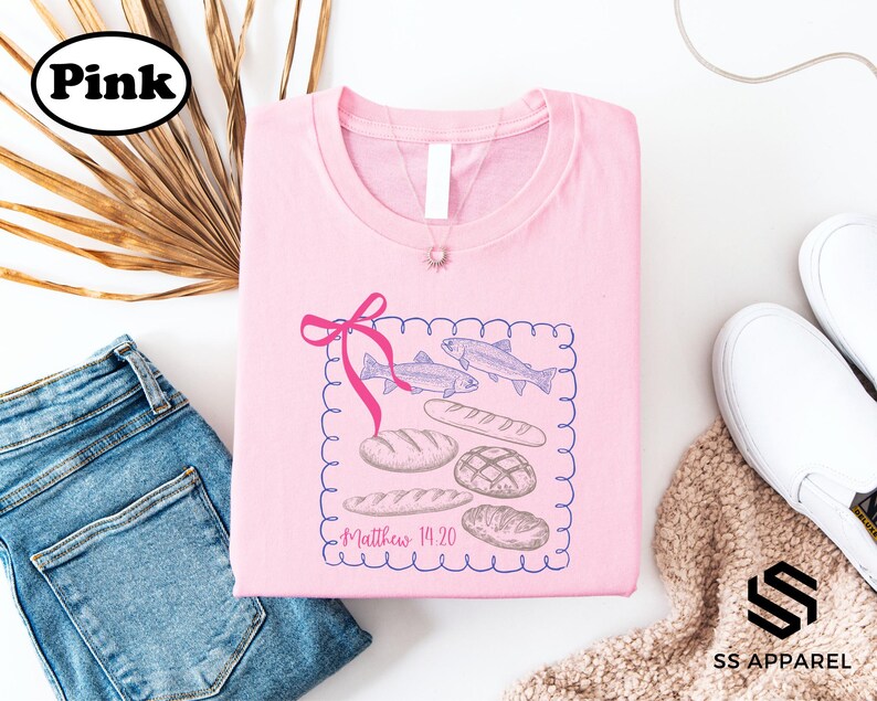 a pink t-shirt with a graphic design, a pair of blue jeans, a pair of white sneakers, and some decorative elements such as a plant and a ribbon.