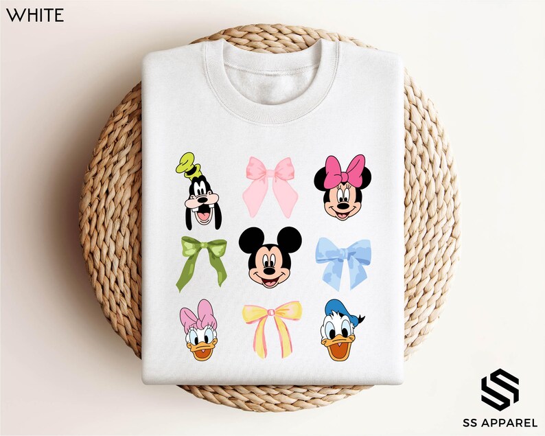 a white shirt with mickey mouse and other cartoon characters on it