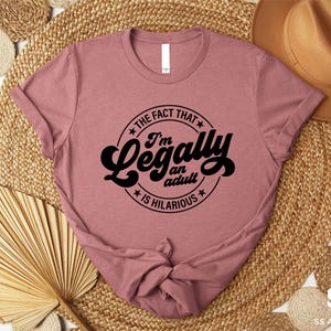 a pink t - shirt that says i'm not that legally