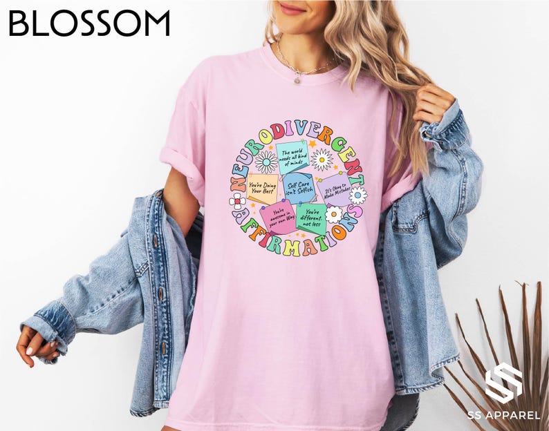 a woman wearing a pink t - shirt with the words love is all around her