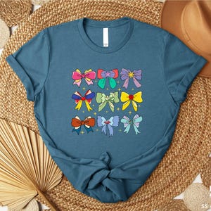 a blue t - shirt with bows on it