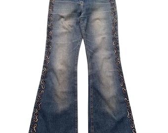 May include: Blue denim flared jeans with decorative sequin trim along the sides. The jeans have a faded wash and a high waist. The brand name "town" is visible on the waistband.