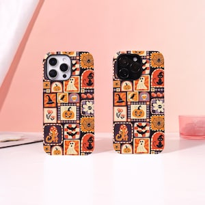May include: Two rectangular phone cases featuring a repeating Halloween-themed pattern. The design includes orange, black, and white squares with illustrations of pumpkins, black cats, ghosts, bats, spiderwebs, mushrooms, and witch hats.