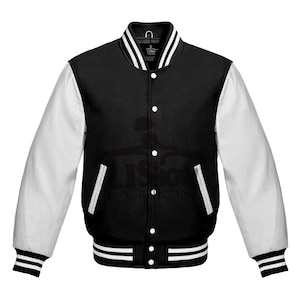 May include: A black varsity jacket with white sleeves, collar, and pocket trim. The jacket features a button-up front, ribbed cuffs, and a striped hem. A classic athletic-inspired outerwear piece.