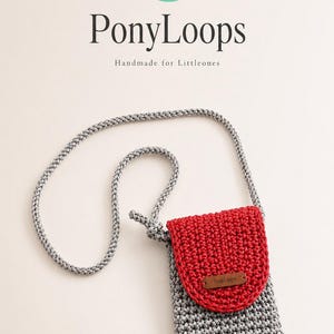 May include: A gray crocheted pouch with a red flap and a long gray braided cord strap. The flap features a small brown rectangular tag with the text PonyLoops. Above the pouch, the text PonyLoops and Handmade for Littleones is visible.