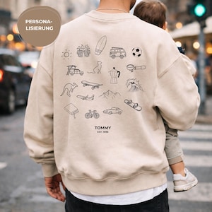May include: A beige crewneck sweatshirt featuring a collection of black line art icons on the back, including a sun, beer mugs, surfboard, van, football, cat, coffee maker, kangaroo, skateboard, wave, aeroplane, mountain, book, bicycle, car, and snowboard, with the text "TOMMY EST. 1996" printed below.