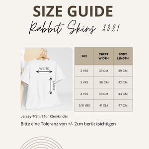 May include: A size guide for Rabbit Skins 3321 t-shirts. The guide shows chest width and body length measurements in centimeters for sizes 2 YRS to 5/6 YRS. The text on the shirt reads "WEITE" and "L&Auml;NGE".