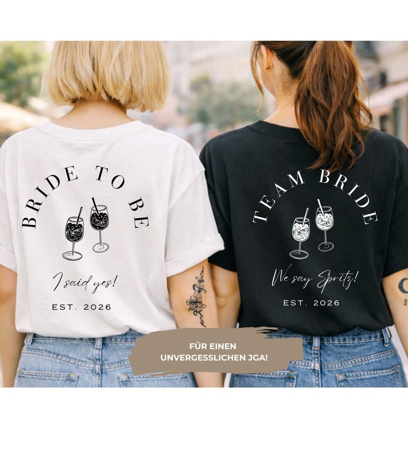 May include: Two t-shirts, one white and one black, with matching designs. The white shirt says "Bride to Be" with "I said yes!" and "EST. 2026". The black shirt says "Team Bride" with "We say Spritz!" and "EST. 2026". Both shirts feature cocktail illustrations.