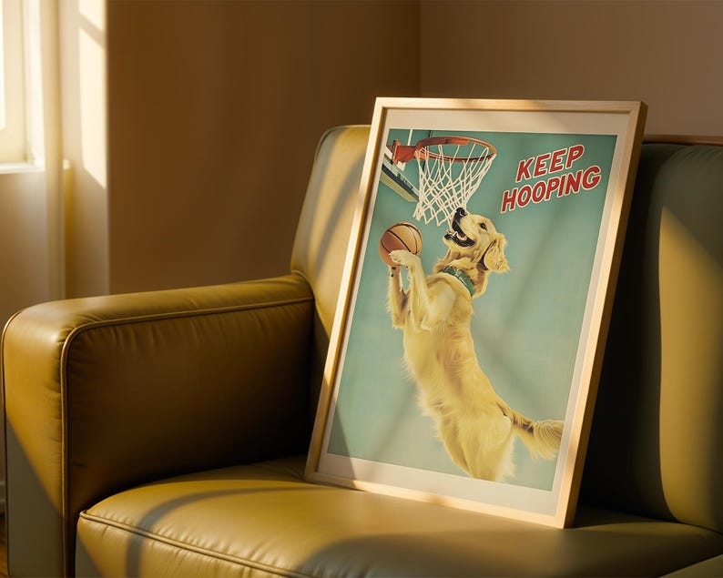 May include: A framed print featuring a golden retriever playing basketball. The dog is jumping to shoot a basketball into a hoop. The print has a light blue background and the words "KEEP HOOPING" in red.