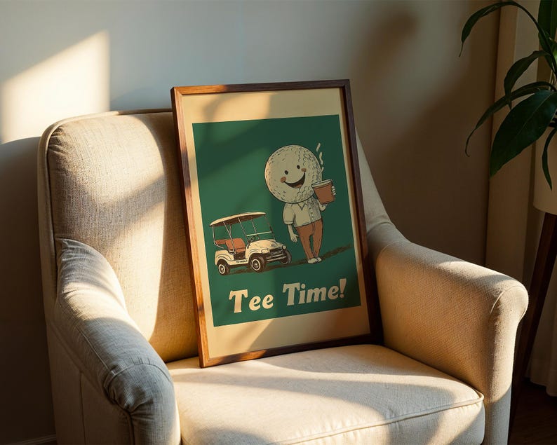 May include: A framed print with a green background featuring a cartoon golf ball character holding a cup of coffee and a golf cart. The text "Tee Time!" is printed below the character.