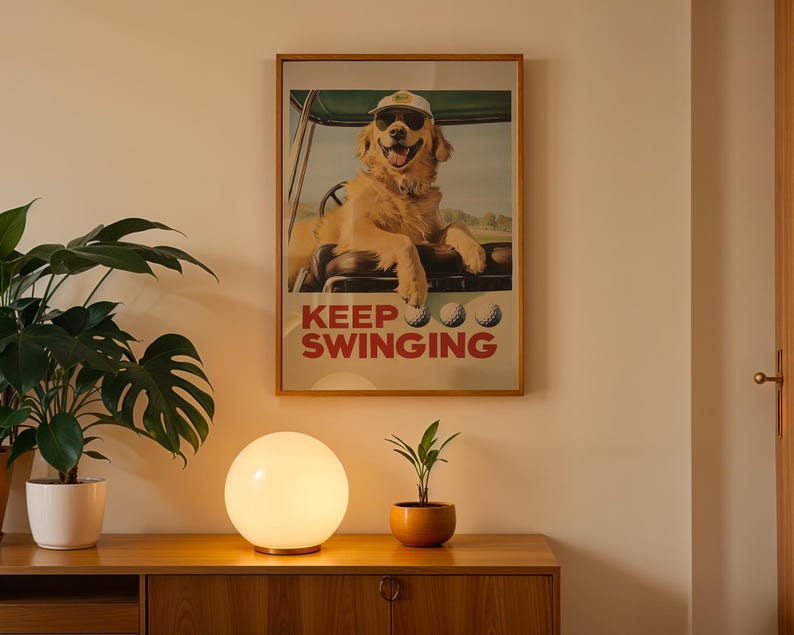 May include: A framed poster with a golden retriever wearing a golf cap and sunglasses, sitting in a golf cart. The poster has the text "Keep Swinging" in red and white letters.
