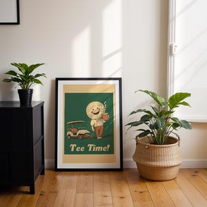 May include: A framed print with a green background featuring a cartoon character holding a cup of coffee and a golf cart. The text "Tee Time!" is printed below the character.