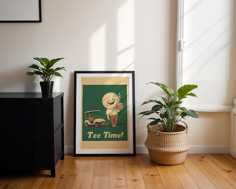 May include: A framed print with a green background featuring a cartoon character holding a cup of coffee and a golf cart. The text "Tee Time!" is printed below the character.