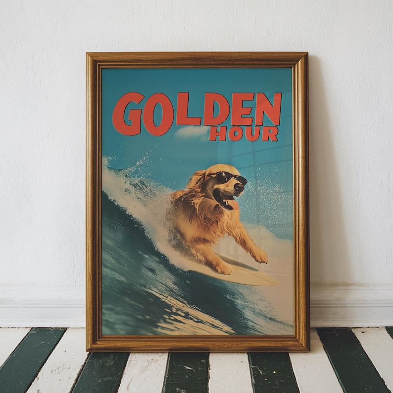 May include: Framed print featuring a golden retriever surfing a wave, wearing sunglasses. The print has the words "GOLDEN HOUR" in red letters against a blue sky background. The frame is a warm brown color.