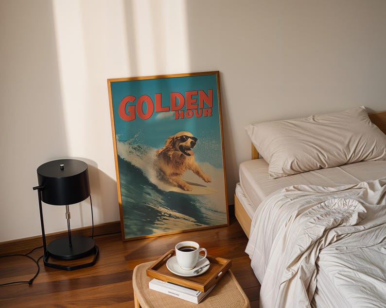 May include: A framed poster with a surfing golden retriever wearing sunglasses, the words "GOLDEN HOUR" in red, and a blue and white background. A black lamp, a wooden tray with a coffee cup, and a bed with beige bedding are also visible.