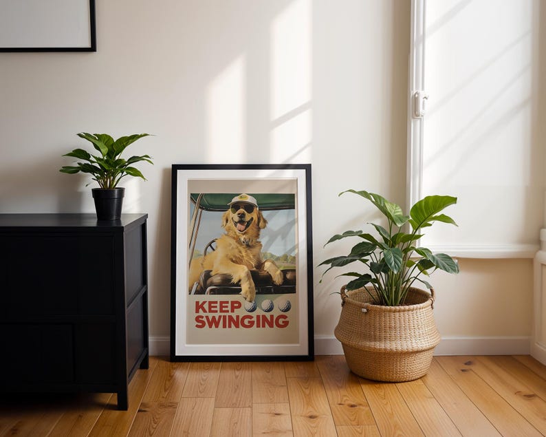 May include: A framed poster with a golden retriever wearing sunglasses and a golf cap. The dog is sitting in a golf cart. The poster has the text "KEEP SWINGING" in red and white letters.
