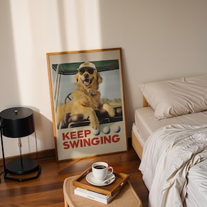 May include: A framed poster with a golden retriever wearing sunglasses and a golf hat driving a golf cart. The poster has the text "Keep Swinging" in red and white letters.