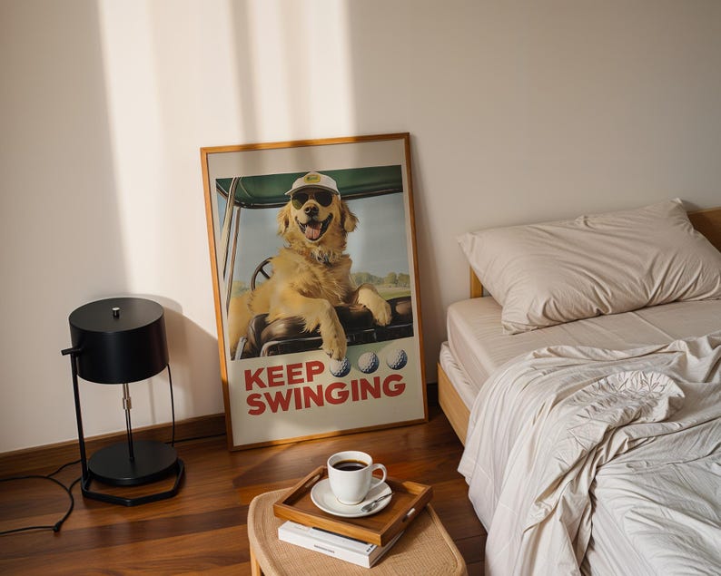 May include: A framed poster with a golden retriever wearing sunglasses and a golf hat driving a golf cart. The poster has the text "Keep Swinging" in red and white letters.
